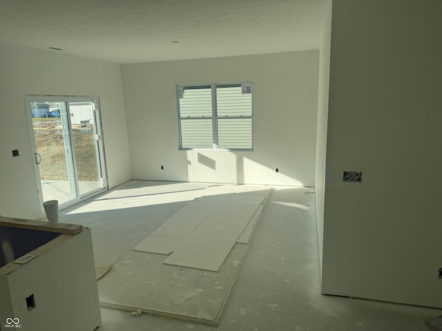 spare room with a textured ceiling