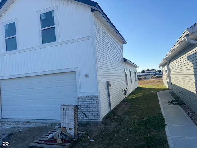 view of side of home featuring a garage and central air condition unit