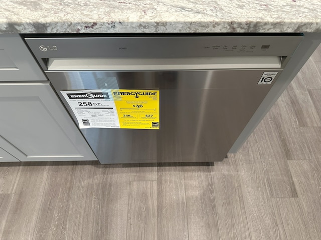 interior details featuring dishwashing machine and light wood-type flooring