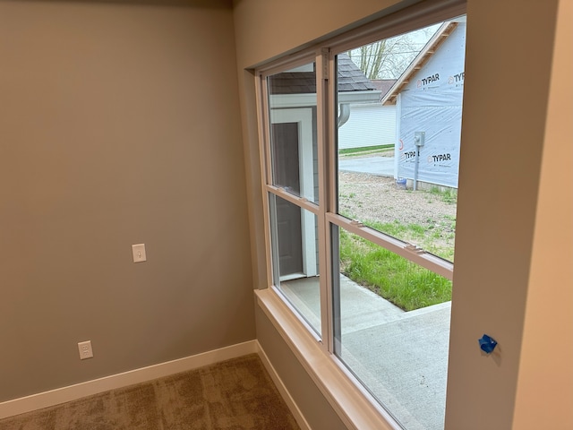 doorway to outside featuring carpet