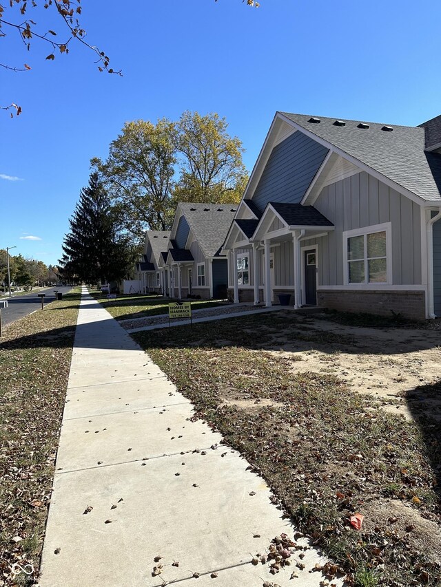 863 E Harrison St, Martinsville, IN 46151 - exterior space featuring brick siding, board and batten siding, and roof with shingles