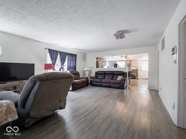 living room featuring a textured ceiling and hardwood / wood-style floors