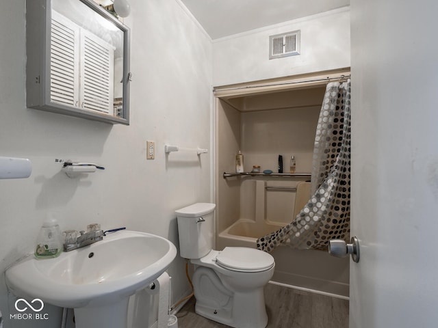 full bathroom featuring sink, shower / bath combo, wood-type flooring, and toilet