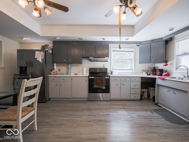 kitchen with range with electric stovetop, a healthy amount of sunlight, and ceiling fan