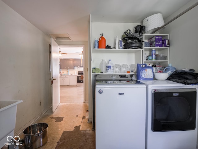 laundry area with light hardwood / wood-style flooring and washer and dryer