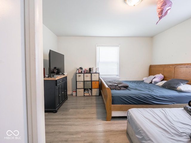 bedroom with hardwood / wood-style flooring