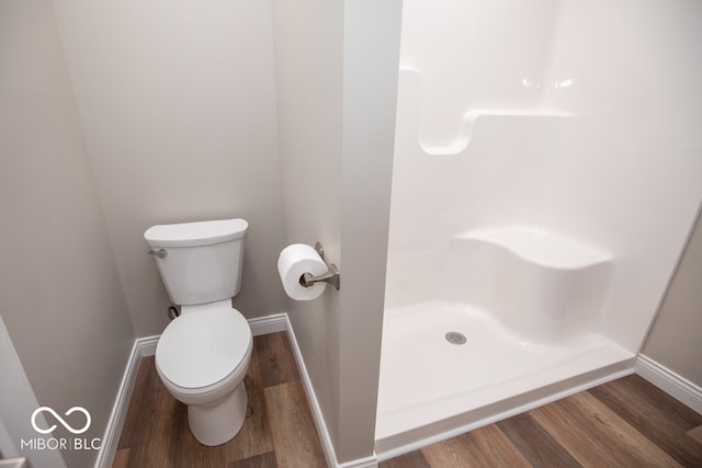 bathroom featuring hardwood / wood-style floors and toilet