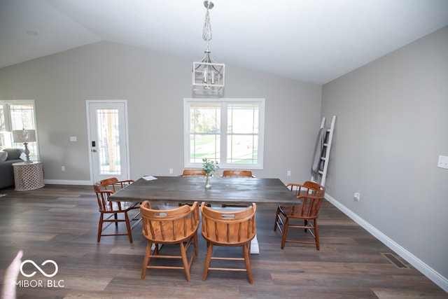 dining area with dark hardwood / wood-style flooring and vaulted ceiling