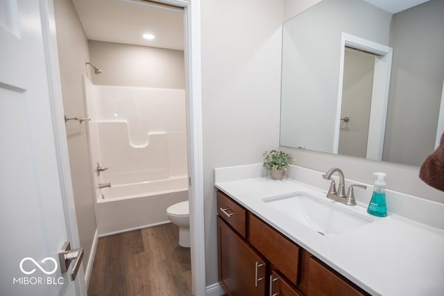 full bathroom featuring vanity, toilet, wood-type flooring, and bathing tub / shower combination