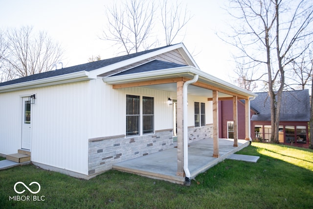 exterior space featuring a lawn and a porch