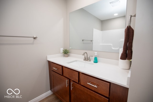 bathroom with hardwood / wood-style floors and vanity