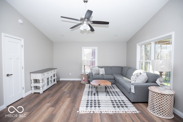 living room featuring dark hardwood / wood-style flooring, vaulted ceiling, and ceiling fan