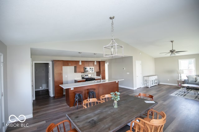 dining room with dark hardwood / wood-style flooring, vaulted ceiling, ceiling fan, and sink