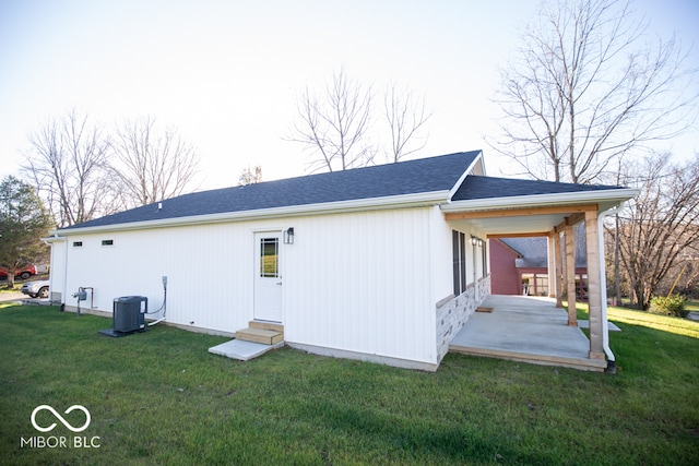 back of house with a lawn, a patio, and central AC