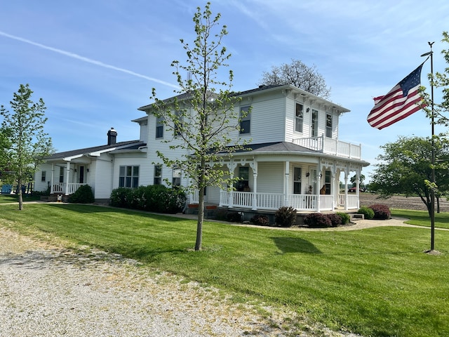 view of front of house featuring a front lawn and covered porch