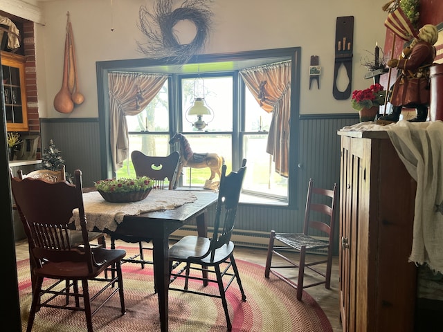 dining room with brick wall and hardwood / wood-style floors