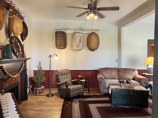 living room featuring hardwood / wood-style floors and ceiling fan