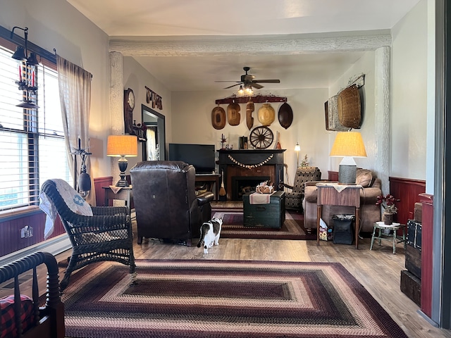 living room with wood-type flooring and ceiling fan