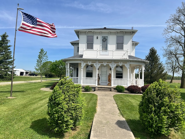 italianate-style house with a front lawn and covered porch