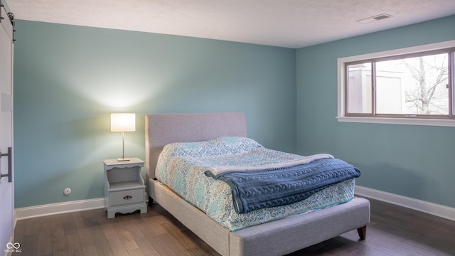 bedroom featuring dark hardwood / wood-style floors