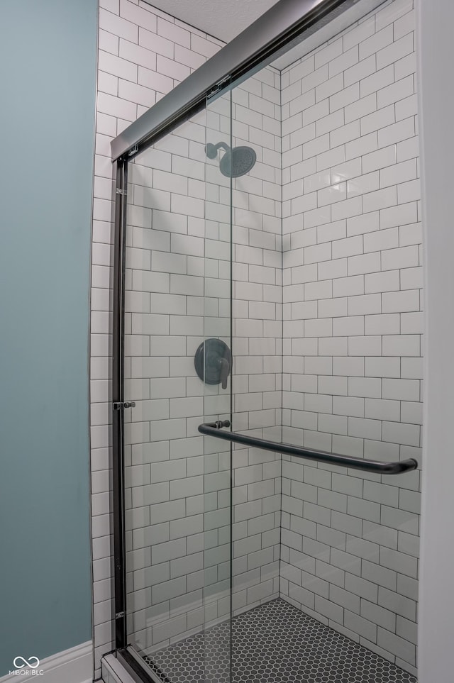 bathroom with a shower with door