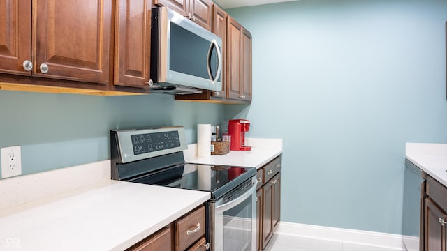 kitchen featuring light tile patterned floors and stainless steel appliances