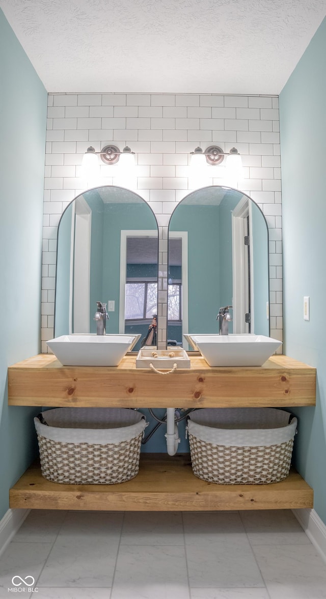 bathroom featuring tile patterned flooring, vanity, and a textured ceiling