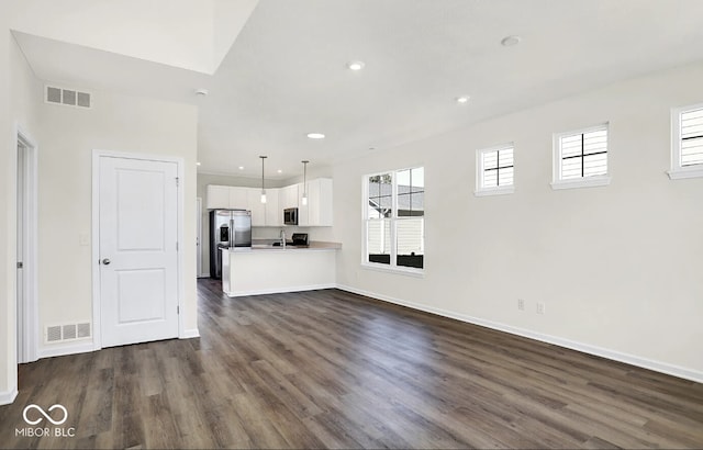 unfurnished living room featuring dark wood-type flooring