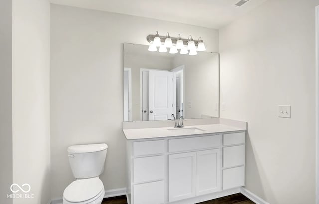 bathroom featuring vanity, hardwood / wood-style floors, and toilet