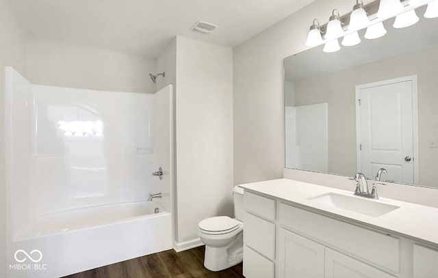 full bathroom with wood-type flooring, vanity, toilet, and washtub / shower combination