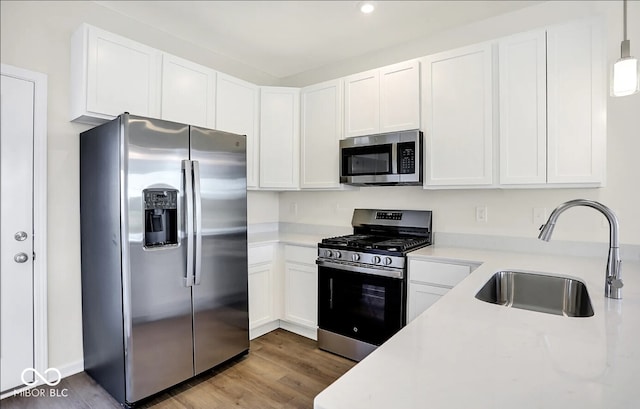 kitchen featuring appliances with stainless steel finishes, sink, and white cabinetry