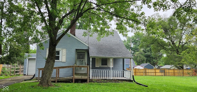 view of front of home featuring a deck and a front lawn