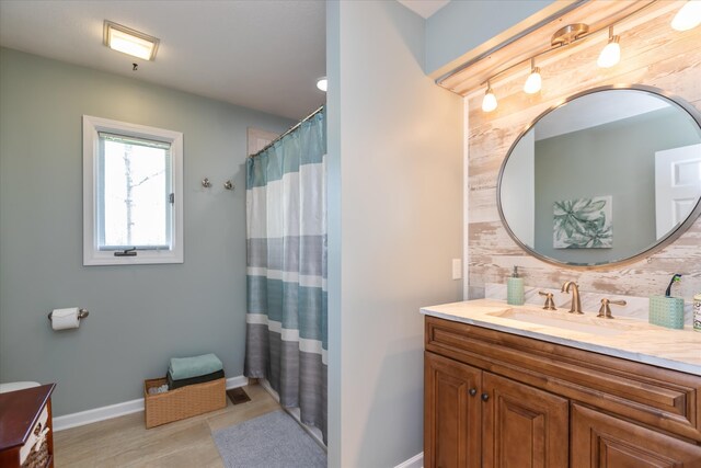 bathroom featuring backsplash, oversized vanity, and tile flooring