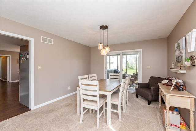 dining space with carpet flooring