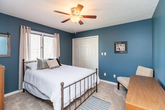 carpeted bedroom with a closet and ceiling fan