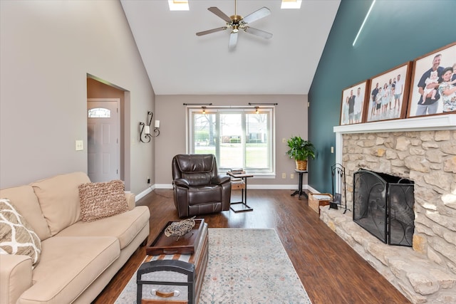 living room featuring high vaulted ceiling, ceiling fan, a fireplace, and dark wood-type flooring