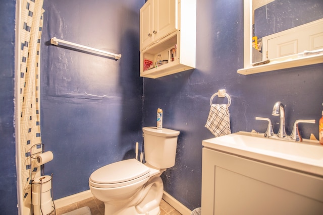 2925 Highwoods Dr, Indianapolis, IN 46222 - bathroom with baseboards, tile patterned flooring, toilet, and vanity