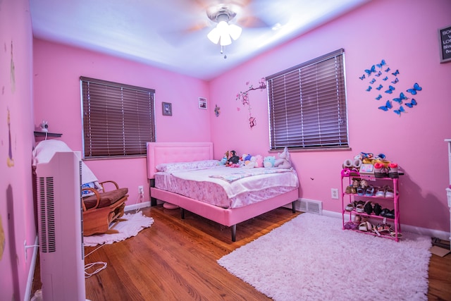 2925 Highwoods Dr, Indianapolis, IN 46222 - bedroom featuring baseboards, ceiling fan, wood finished floors, and visible vents
