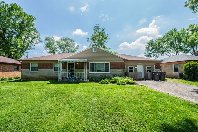 2925 Highwoods Dr, Indianapolis, IN 46222 - ranch-style house with brick siding and a front lawn
