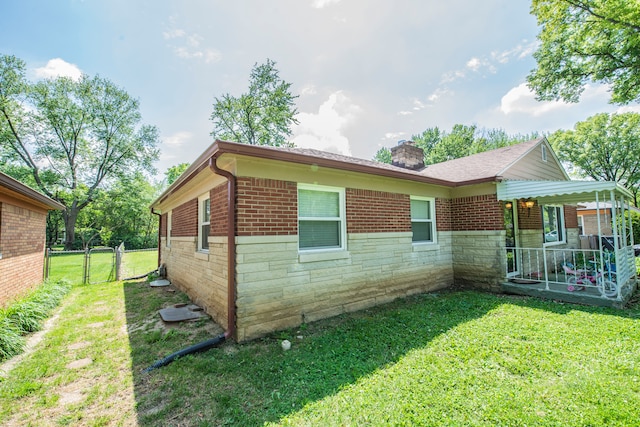 2925 Highwoods Dr, Indianapolis, IN 46222 - view of property exterior with a chimney, a yard, brick siding, and stone siding