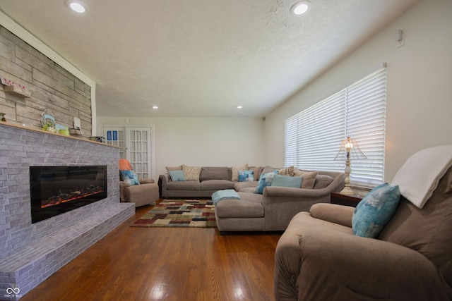 2925 Highwoods Dr, Indianapolis, IN 46222 - living area with recessed lighting, a textured ceiling, wood finished floors, and a fireplace