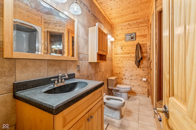 bathroom featuring tile flooring, a bidet, wood walls, vanity, and toilet