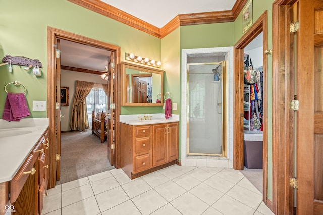 bathroom with tile floors, a shower with door, and crown molding