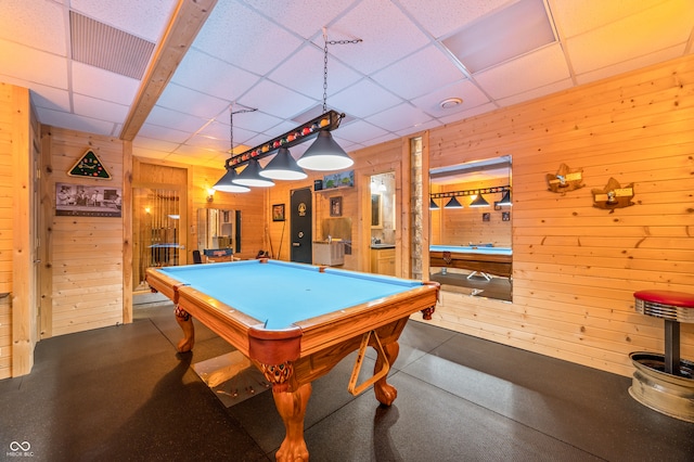 recreation room featuring wooden walls, billiards, and a drop ceiling