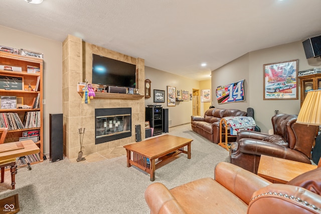 carpeted living room with a textured ceiling, a fireplace, and tile walls