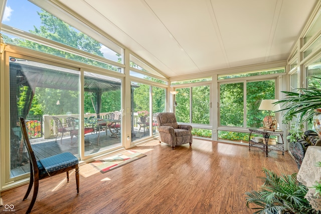 sunroom / solarium featuring plenty of natural light and lofted ceiling