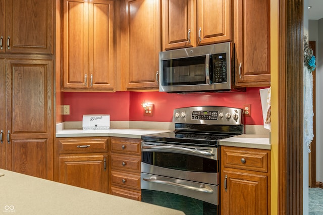 kitchen with tile floors and stainless steel appliances