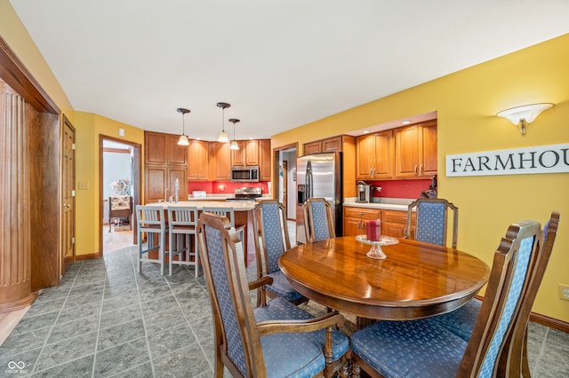 dining space with sink and tile floors