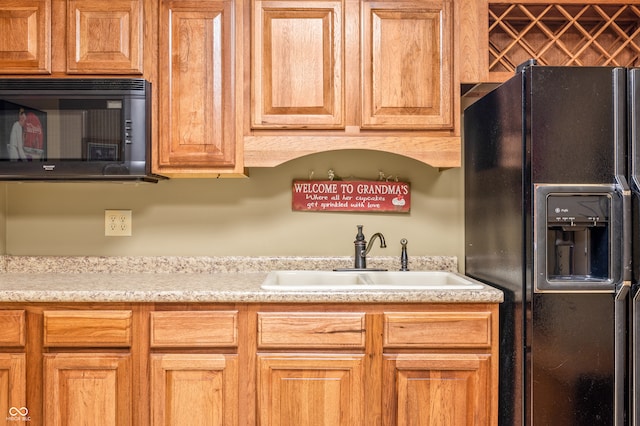 kitchen featuring sink and black appliances