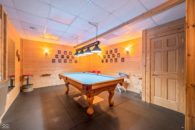 playroom with wooden walls, billiards, and a drop ceiling